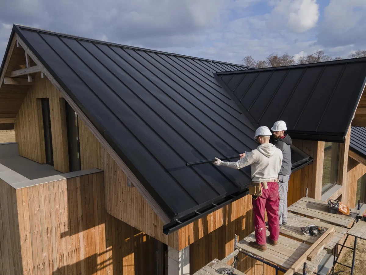 Two workers installing a roof
