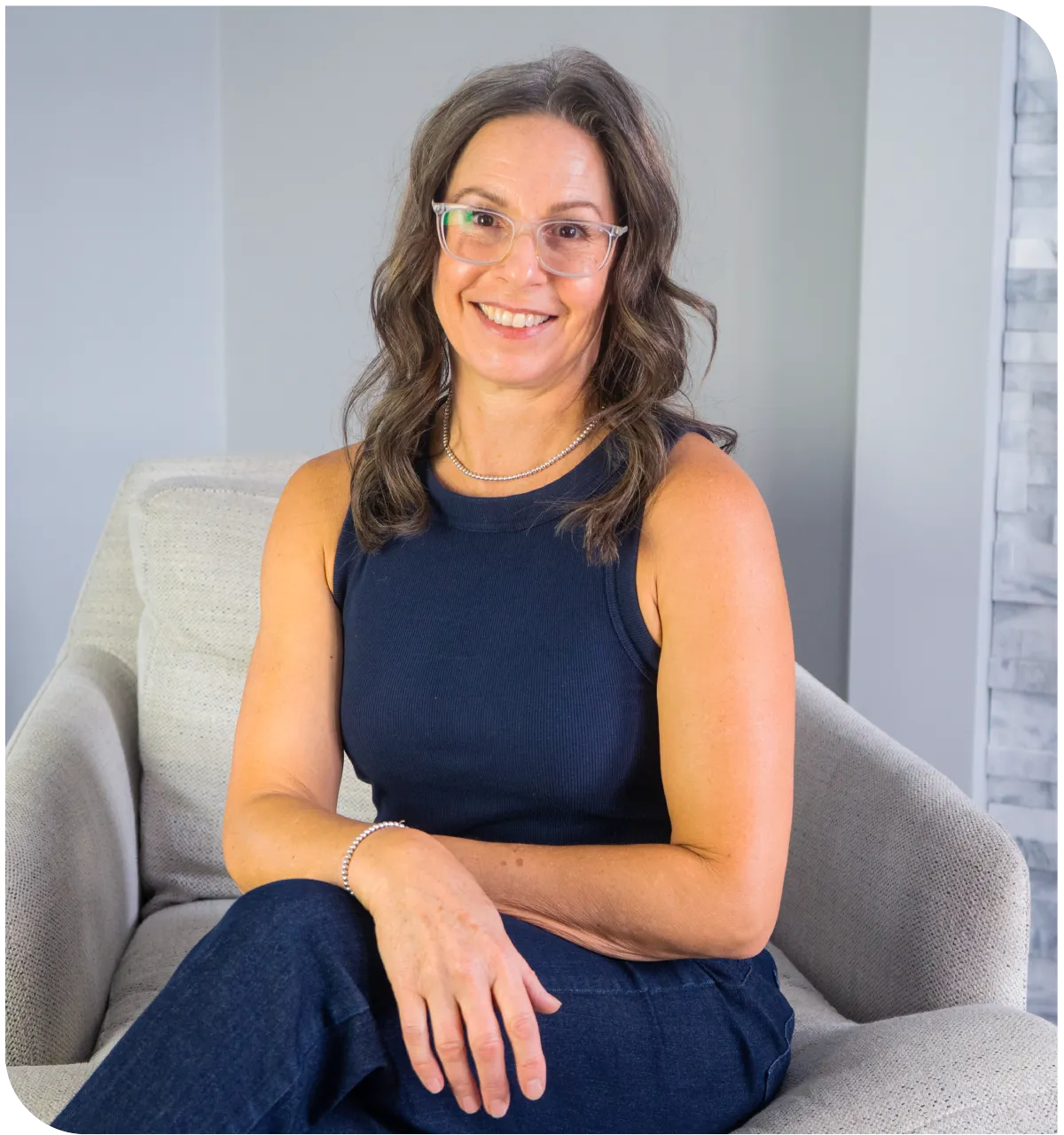 picture of Paula sitting on a chair with legs crossed