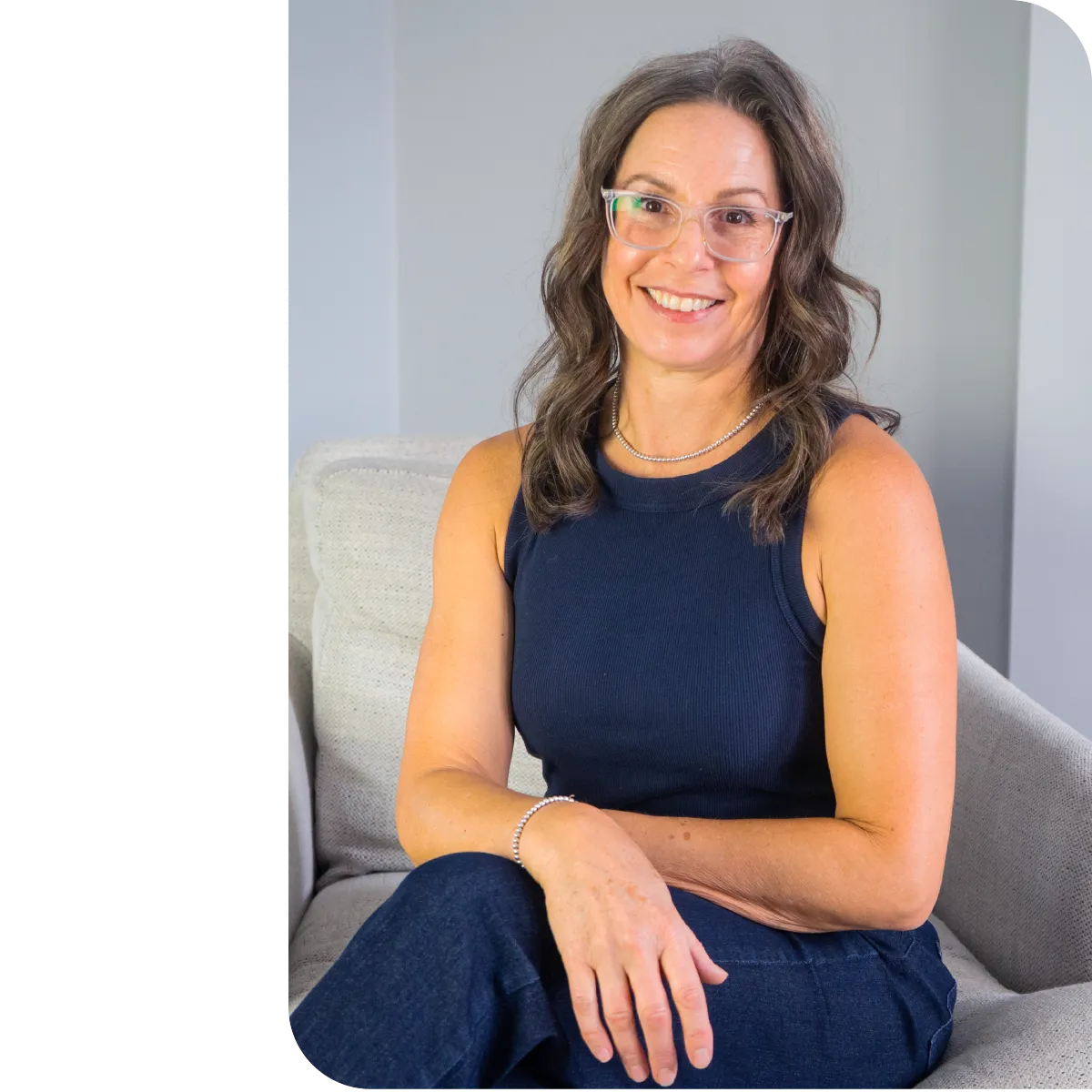 picture of Paula sitting on a chair with legs crossed