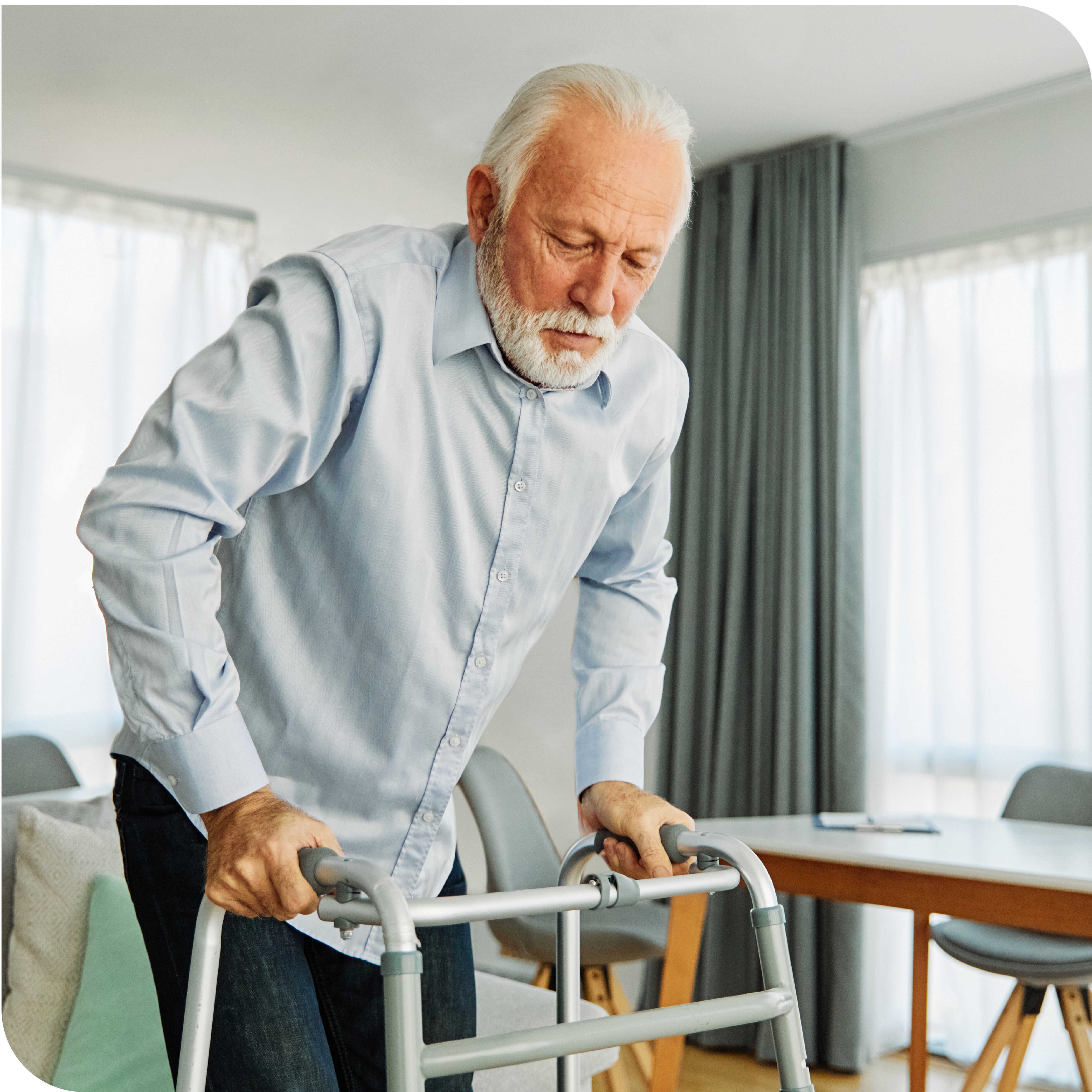 old man using a walker in his home