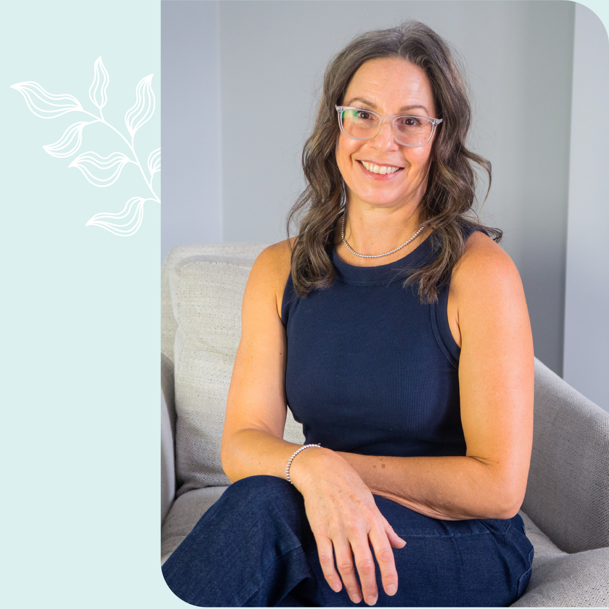 picture of Paula sitting on a chair with legs crossed