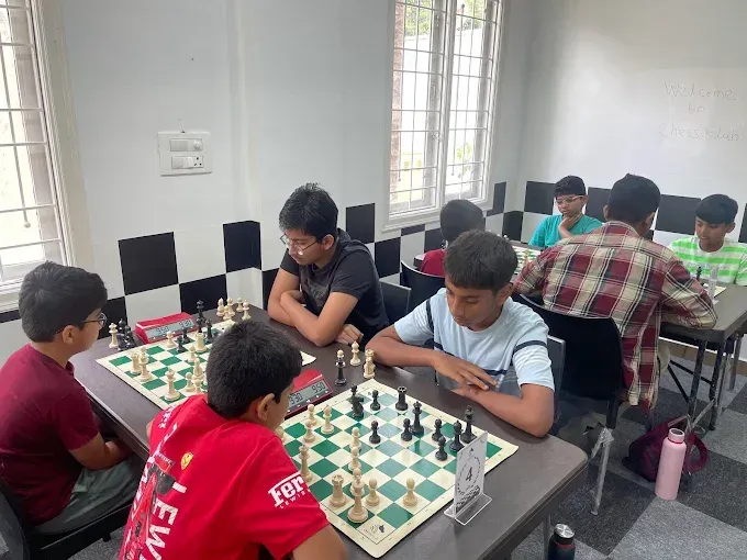 Chess students playing games during a coaching session at CHESS KLUB