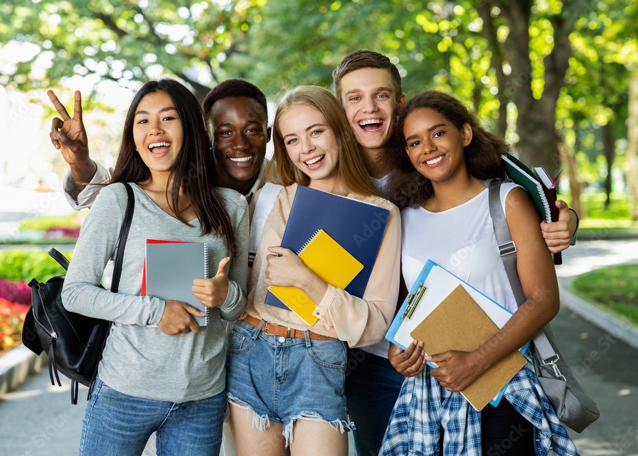 Happy high school students studying together