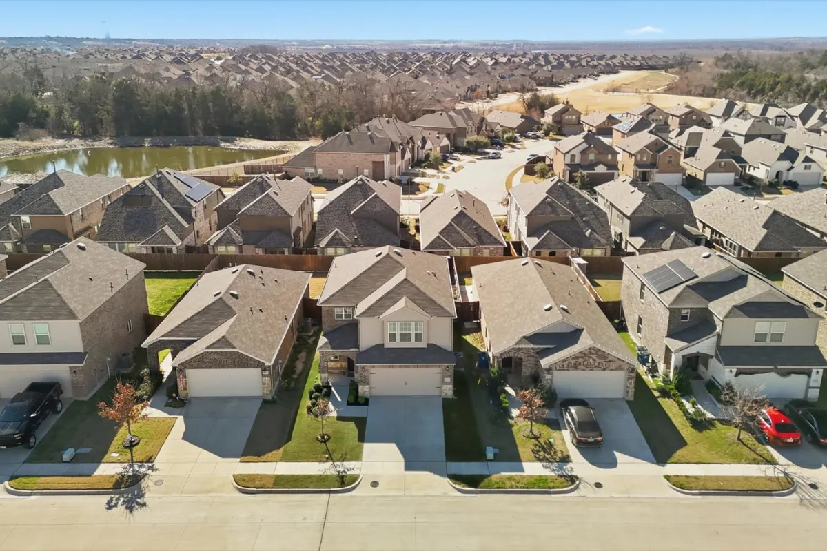 an aerial photo of a 2 story home and neighborhood