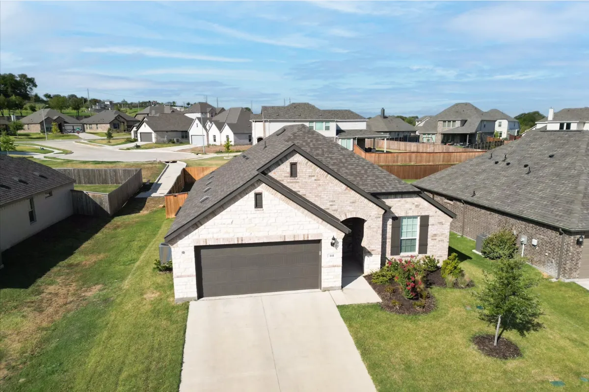 a drone captured image of the front of a white home