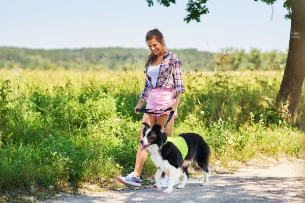 women walking dog on loose leash