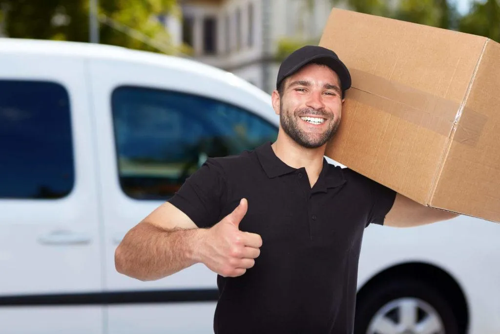 A Young Man Carrying a Box