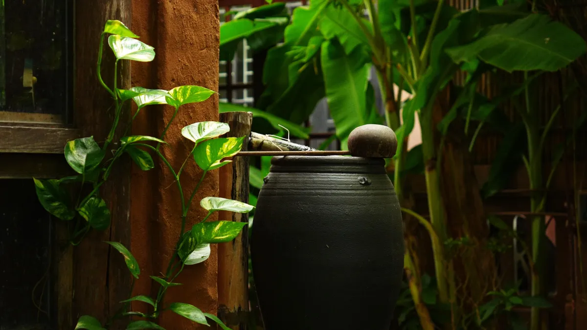 Small wooden building reflected in calm water