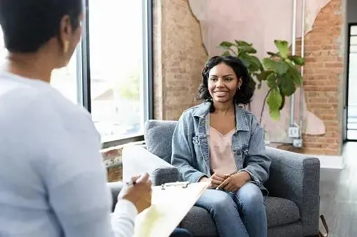 A supportive ACT therapy moment at Cornerstone Wellness Center in Medina, OH, depicting a therapist and client during a transformative breakthrough in a caring setting.