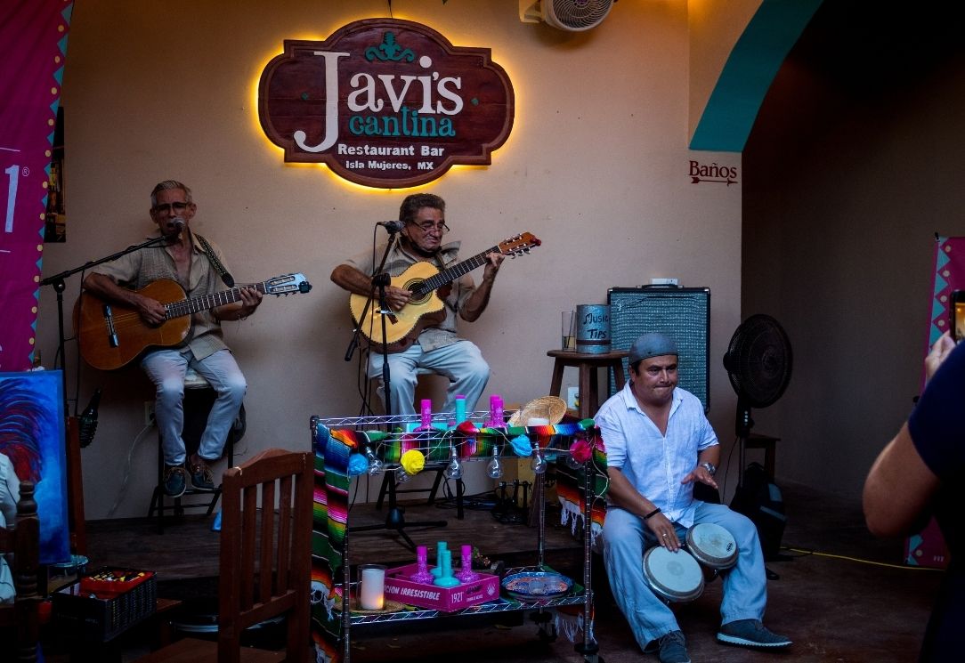 Margaritas being served under nighttime lights at Javi’s Cantina