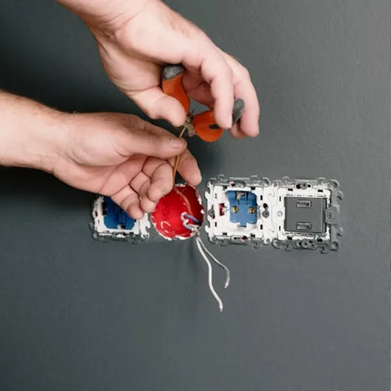 Handyman repairing an electrical socket