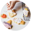 Festive holiday cookies and icing tools set up for a seasonal cookie decorating event
