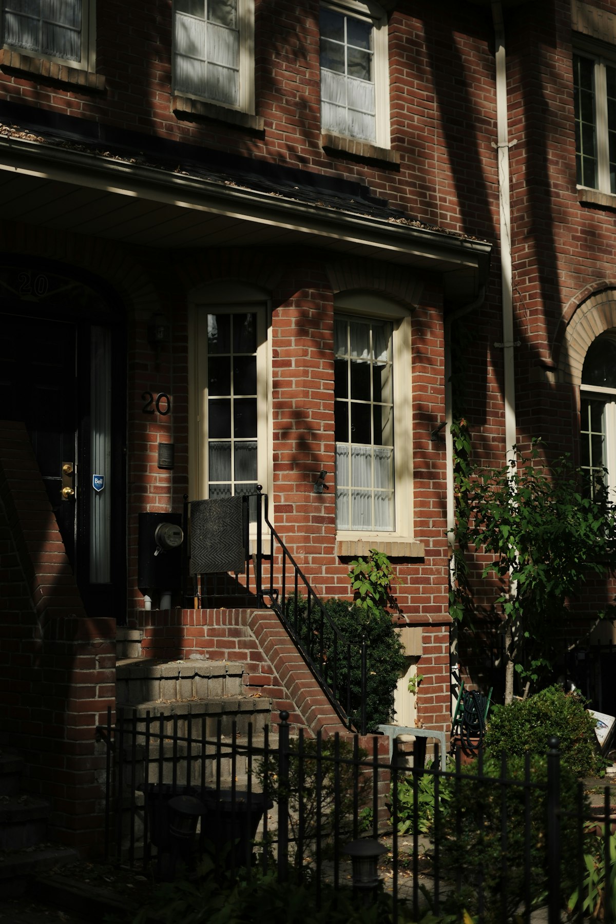 Brick row house entrance on a residential East Toronto street, the kind of housing stock investors finance with a rental mortgage