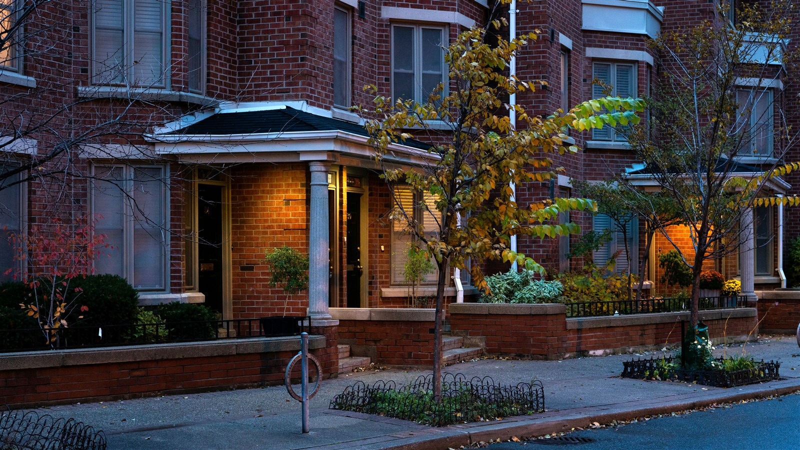 Tree-lined residential street in Riverdale Toronto with Victorian semi-detached homes