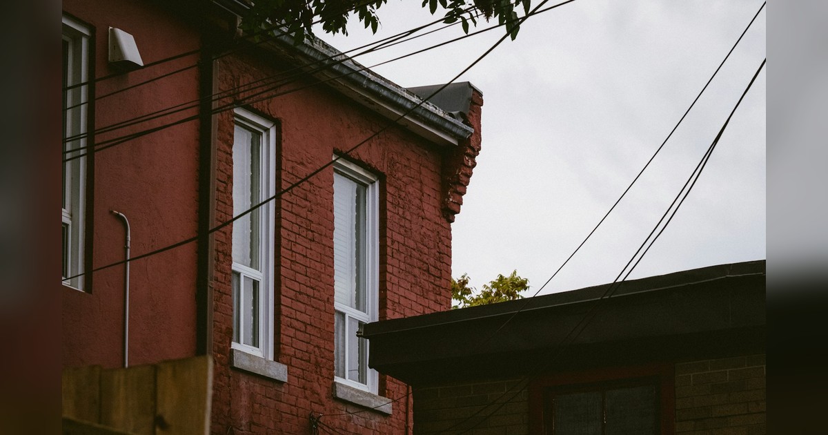 Red brick Toronto residential building, upper-story windows and roofline