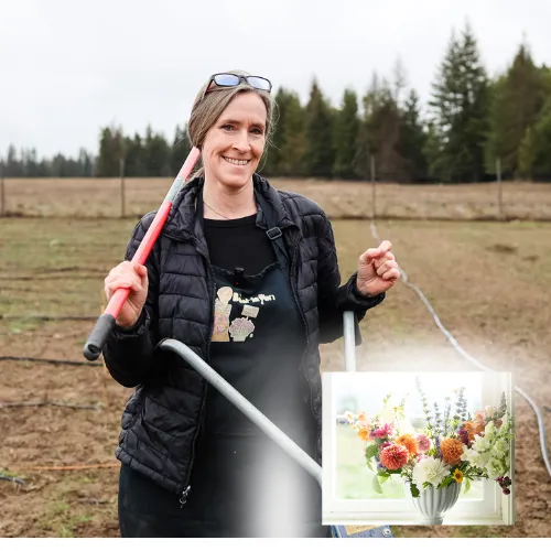 Paula Rice standing in a bare field dirt holding a hoe, ready to plan he perfect cut flower garden.