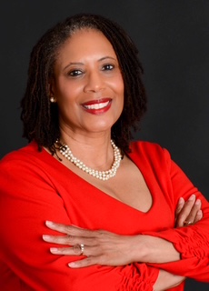 3 women holding brown cardboard box