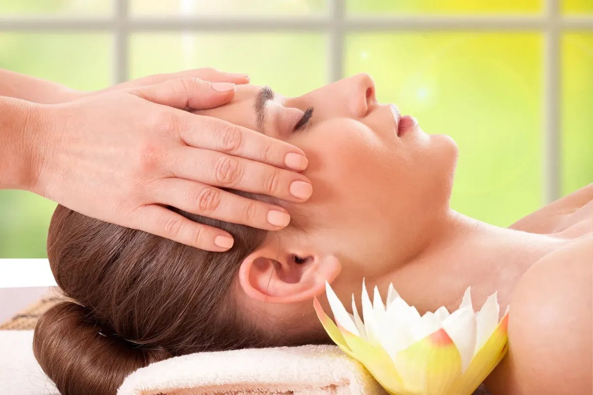 Facial treatment image: serene client with eye mask, soft towels and natural props, spa-like lighting to convey relaxation.