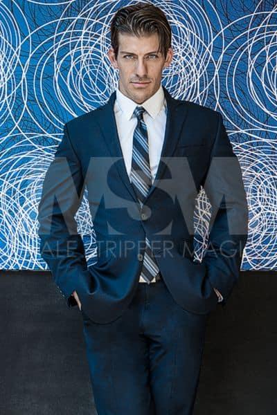 Male stripper Chase in a navy suit looking sharp