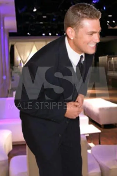 Smliling Male stripper RJ in a sharp suit at a classy event