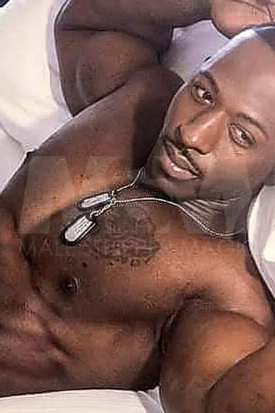 Black male stripper XL contemplating in bed