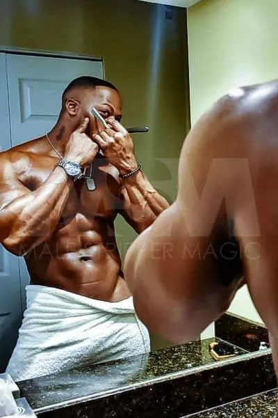 Black male stripper XL shaving in the mirror