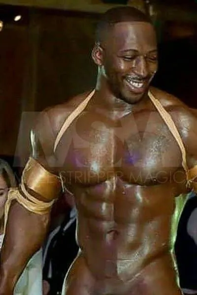 Enthusiastic black male stripper XL dancing for ladies at a male review