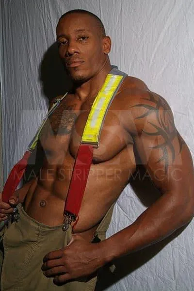 Smiling black male stripper Dante in firefighter gear, without a shirt