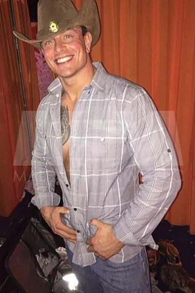 Male stripper Dean dressed as a cowboy, smiling