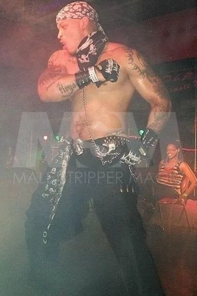Black male stripper Temptation performing on stage at a male revue