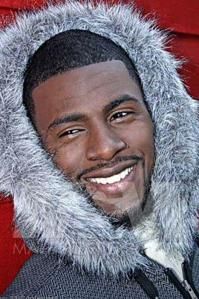 Black male stripper Dream with a big smile, wearing a fuzzy winter coat hood