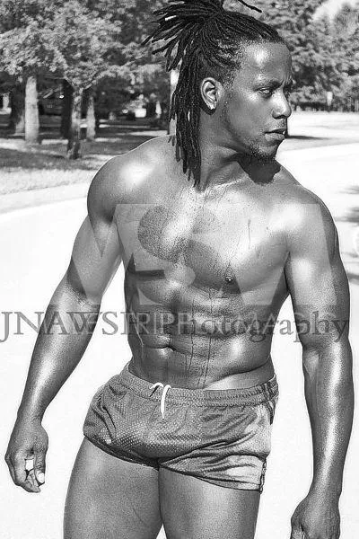 Black male stripper Kingston shirtless with braided ponytail