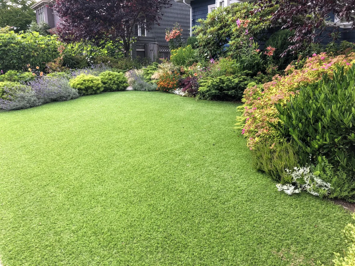 elegant front lawn with flowers, trees, and shrubs