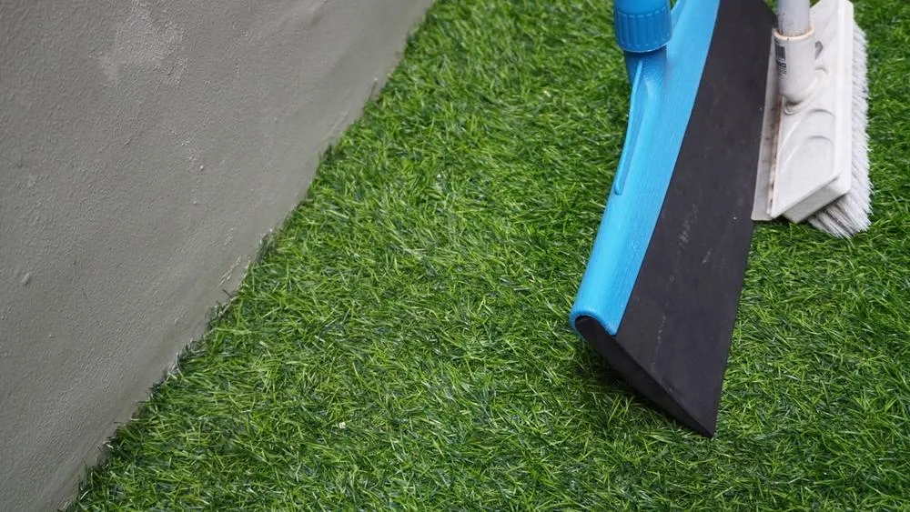 clean turf being sept with broom