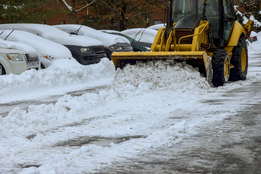 icebreaker truck removing snow in a parking lot
