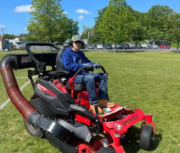 worker measuring hardscape brick installation