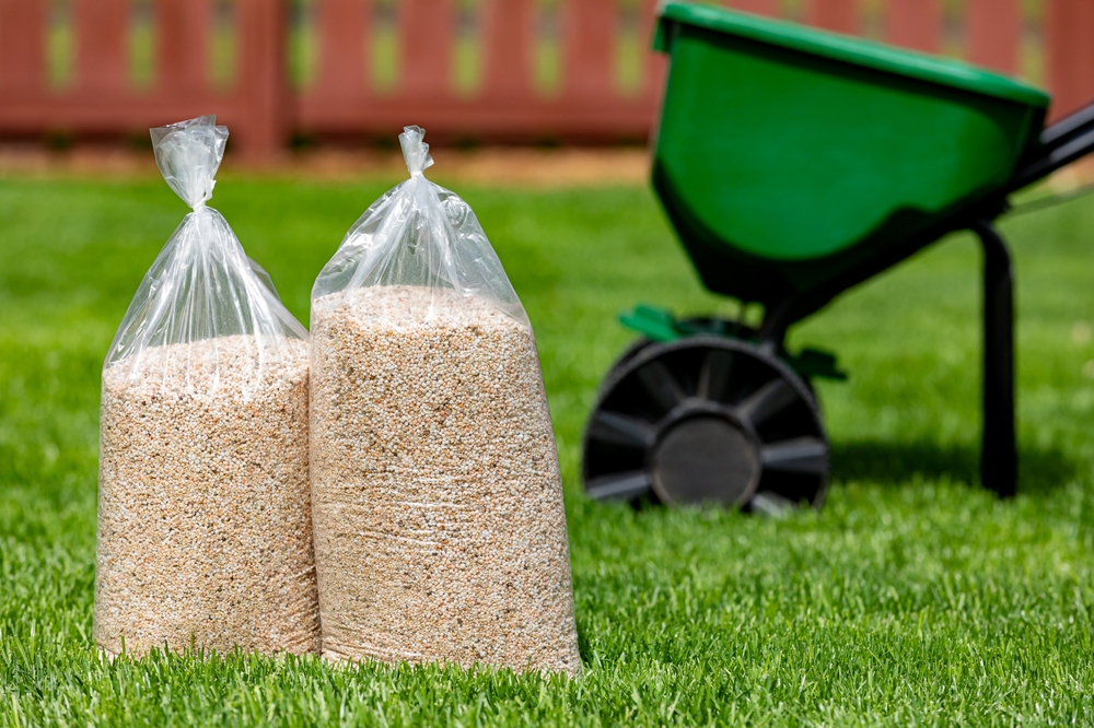 bags of fertilizer on a green lawn