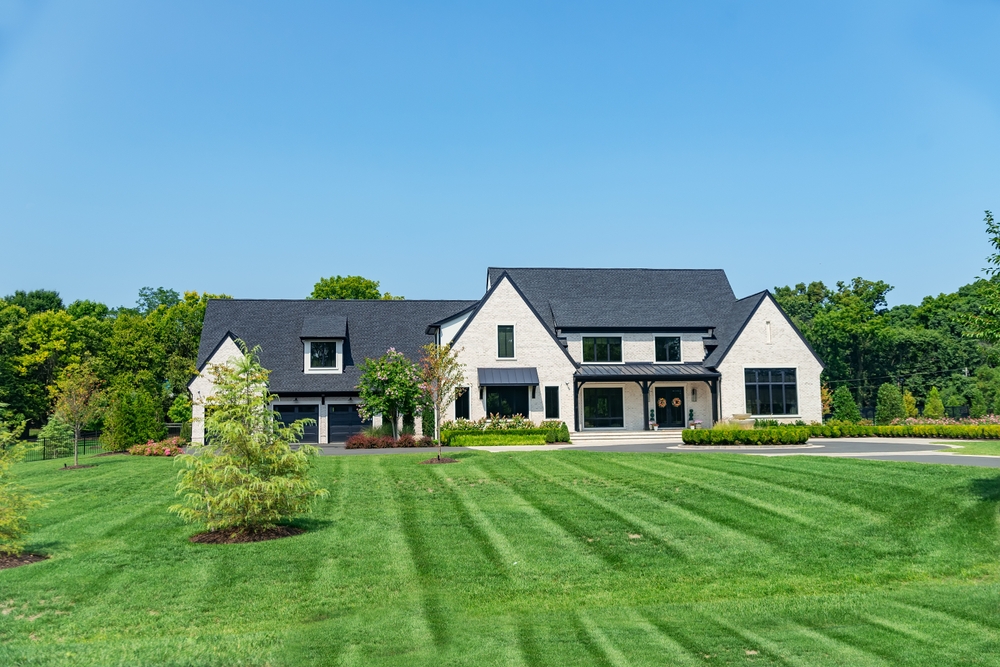 Perfectly cut grass on large lawn of large house