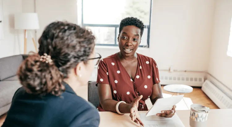 Two people discussing home pricing and selling a house.