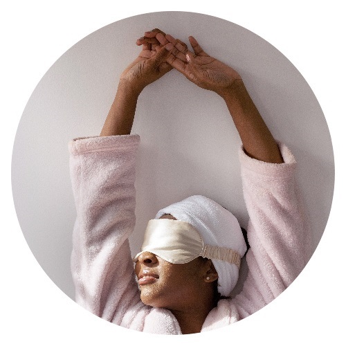 Picture of woman relaxing in pink spa robe and eye mask