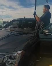 photo of classic white vehicle near pedestrian lane