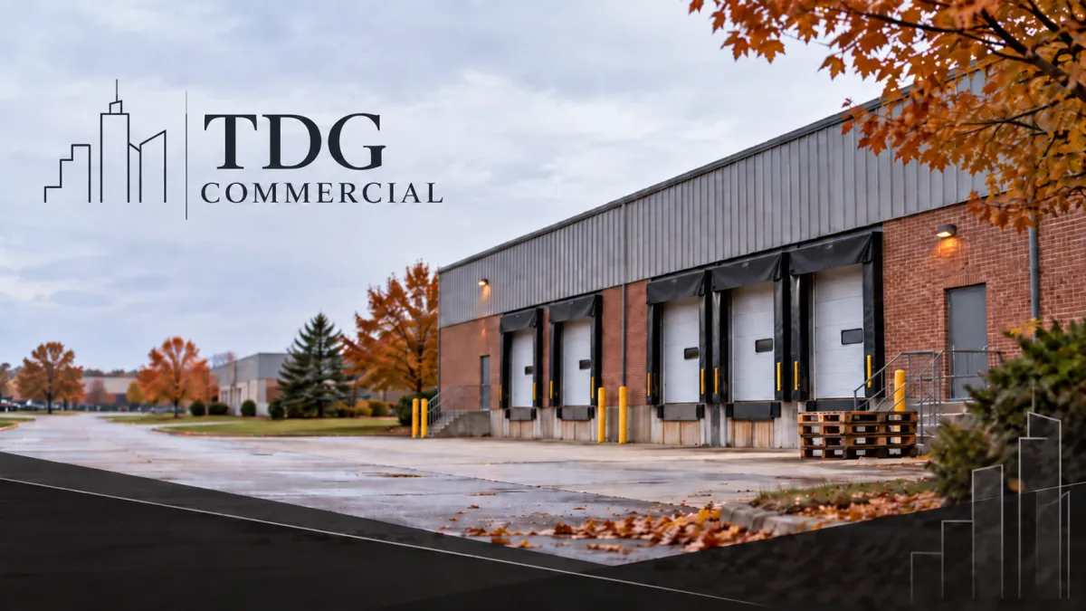 Single-story brick industrial building with closed dock doors in a Macomb County industrial park on a late autumn morning