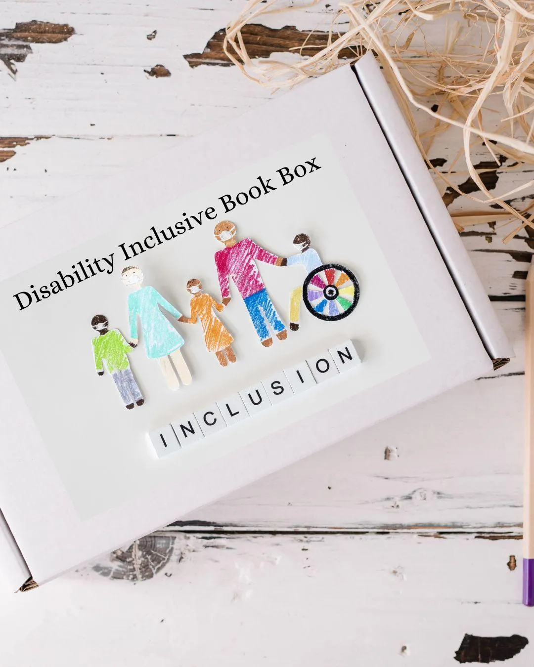 Picure of Disability Inclusive Book Box program several people of different ages and abilities holding hands person on the end is in a wheelchair 