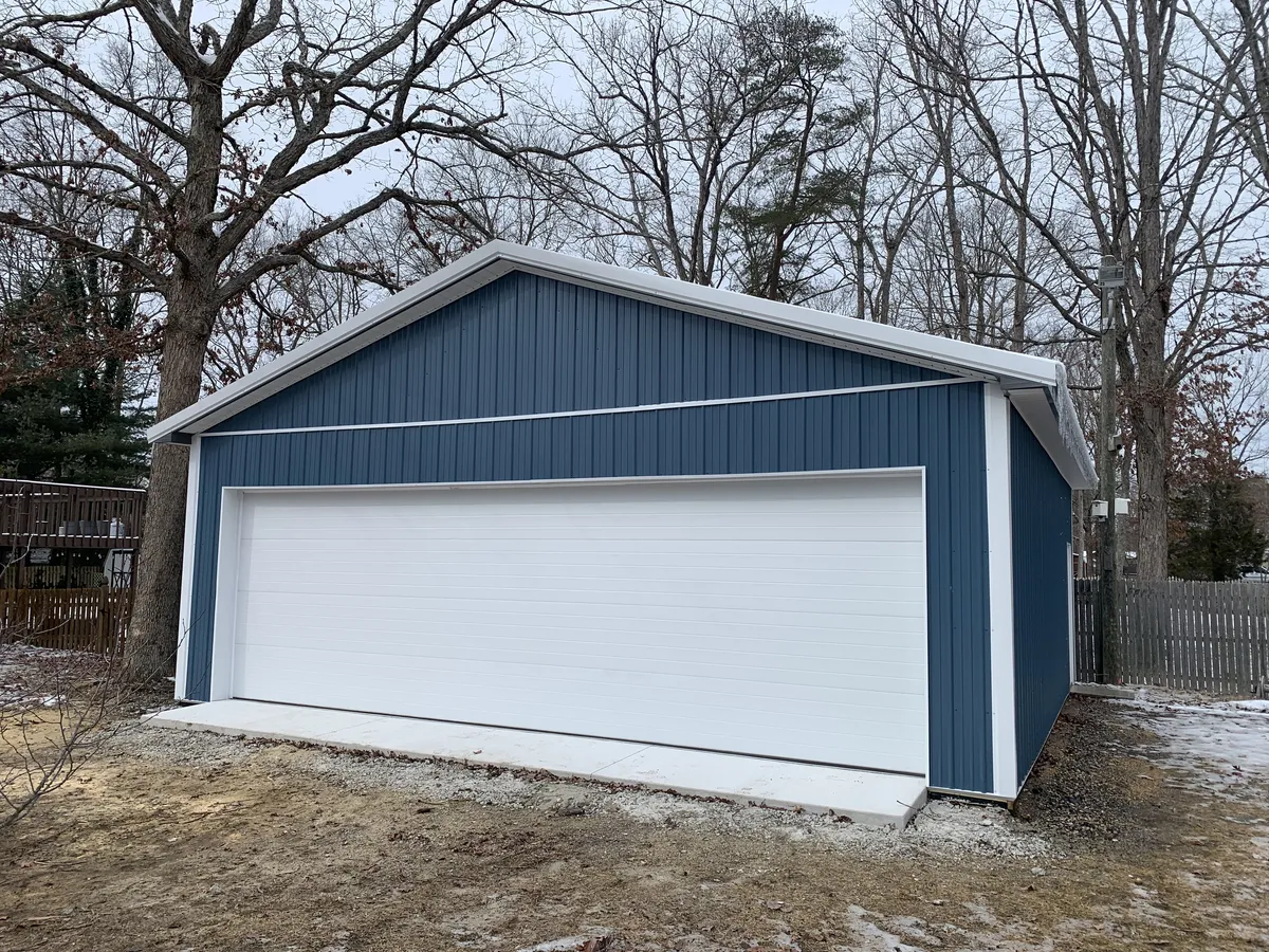Completed blue Cimino garage with wide white overhead door