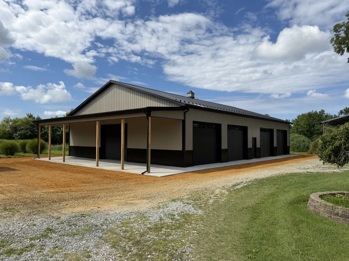 Tan multi-bay pole garage with a covered front porch
