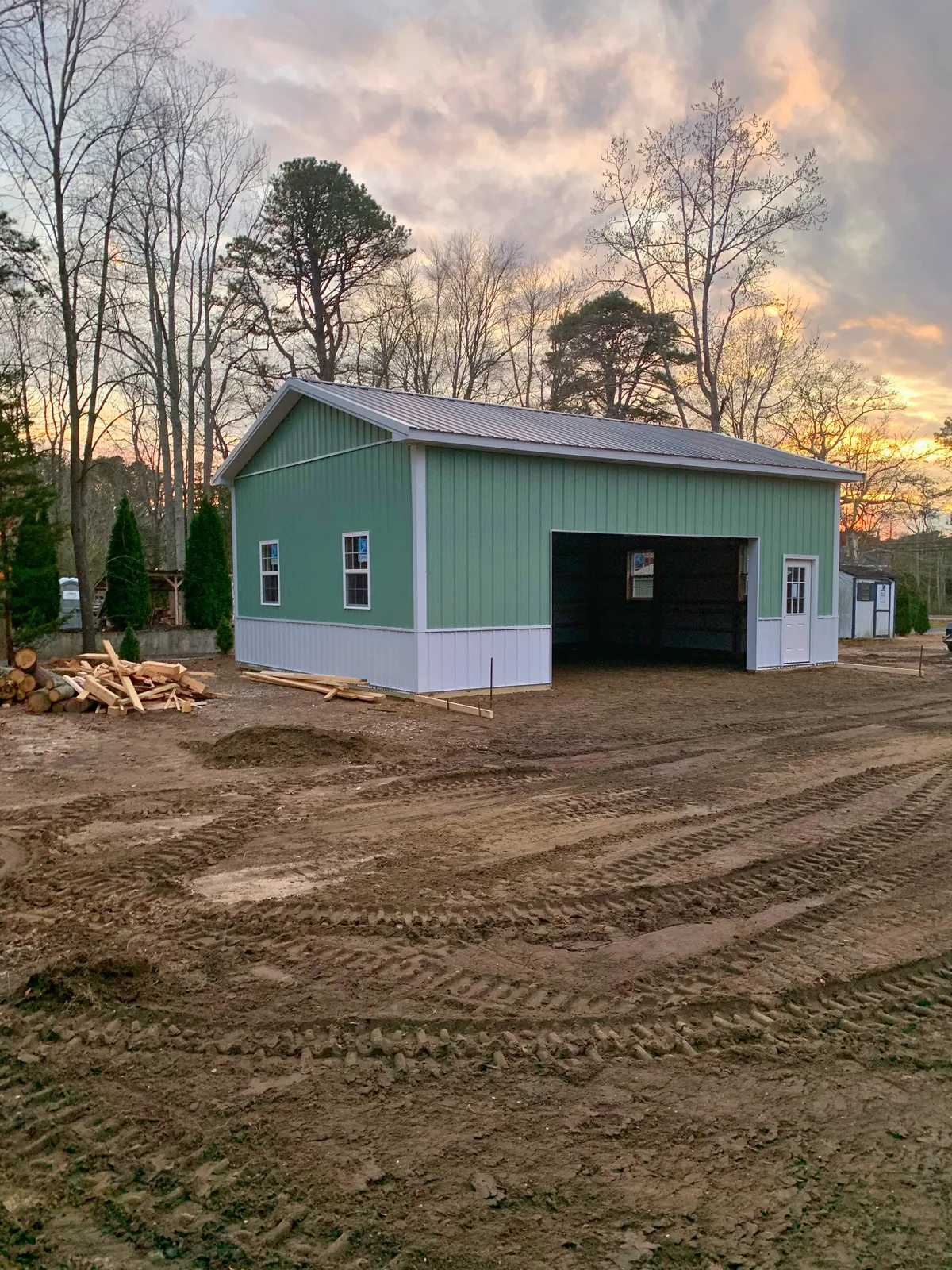 Green pole workshop with white trim during construction