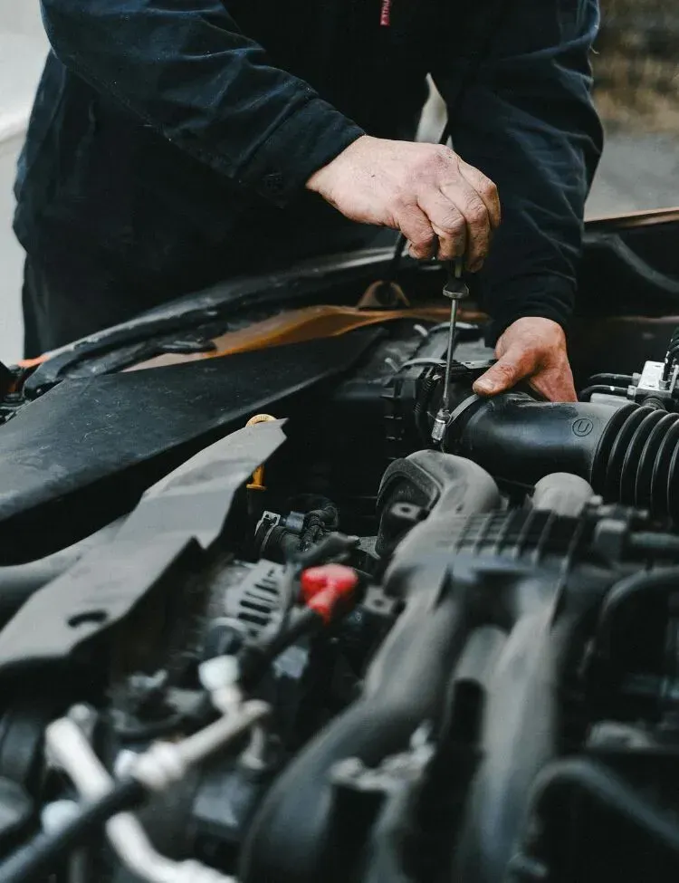 Professional technician completing automotive engine service