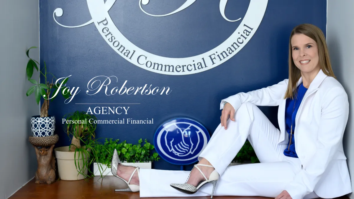 Friendly insurance agent greeting family in Warner Robins office