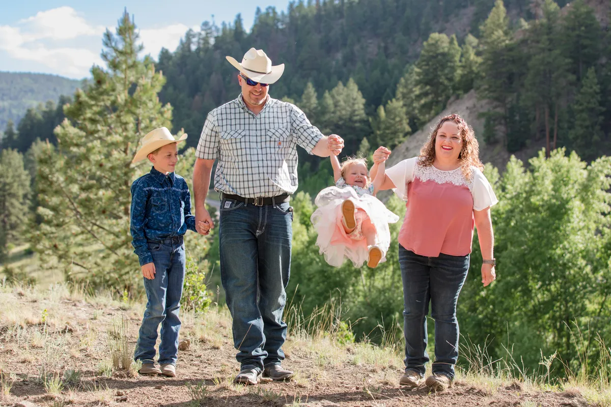 Linette with her family outdoors in the Colorado mountains