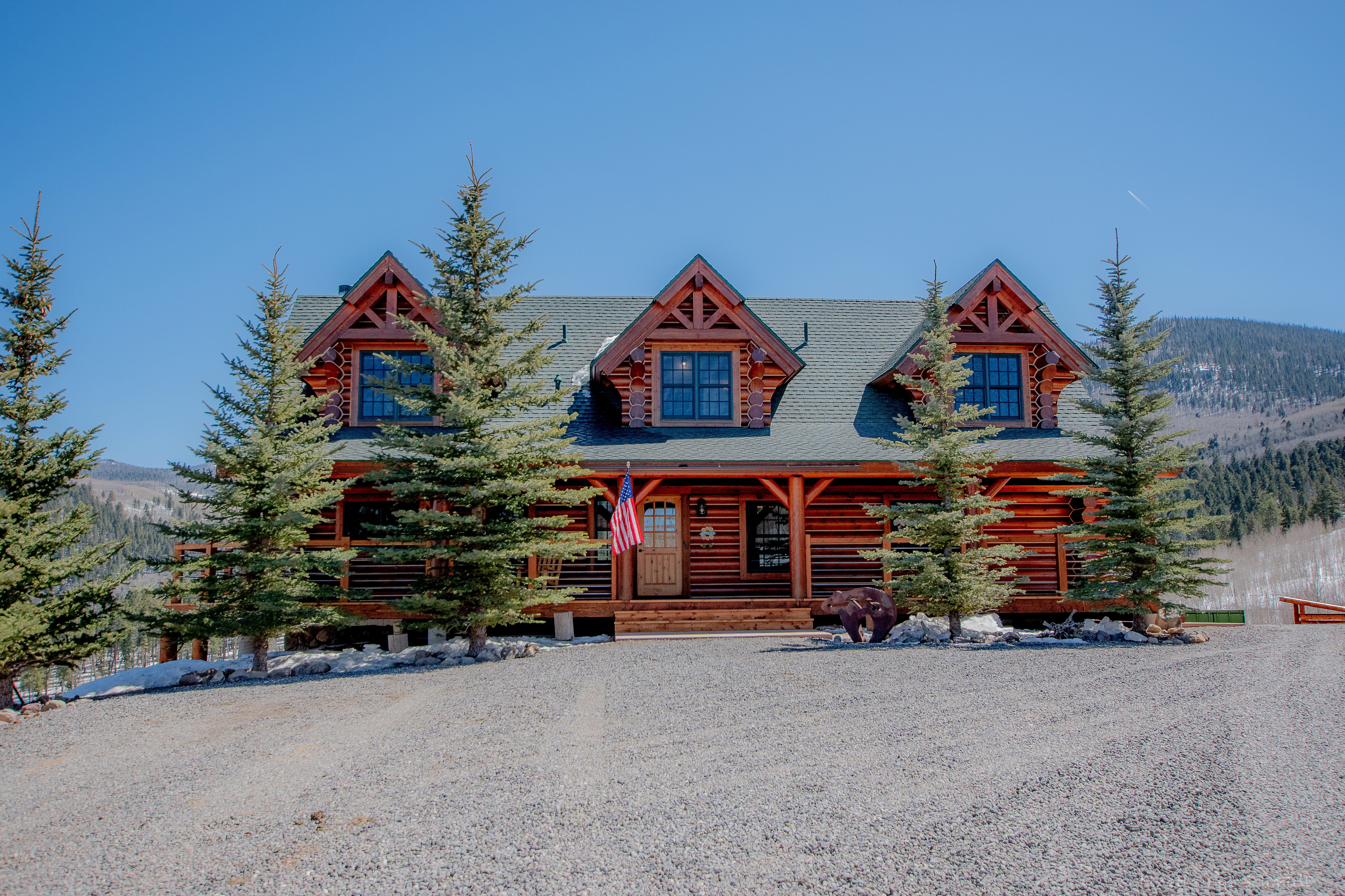 Elk Court mountain home framed by evergreen trees